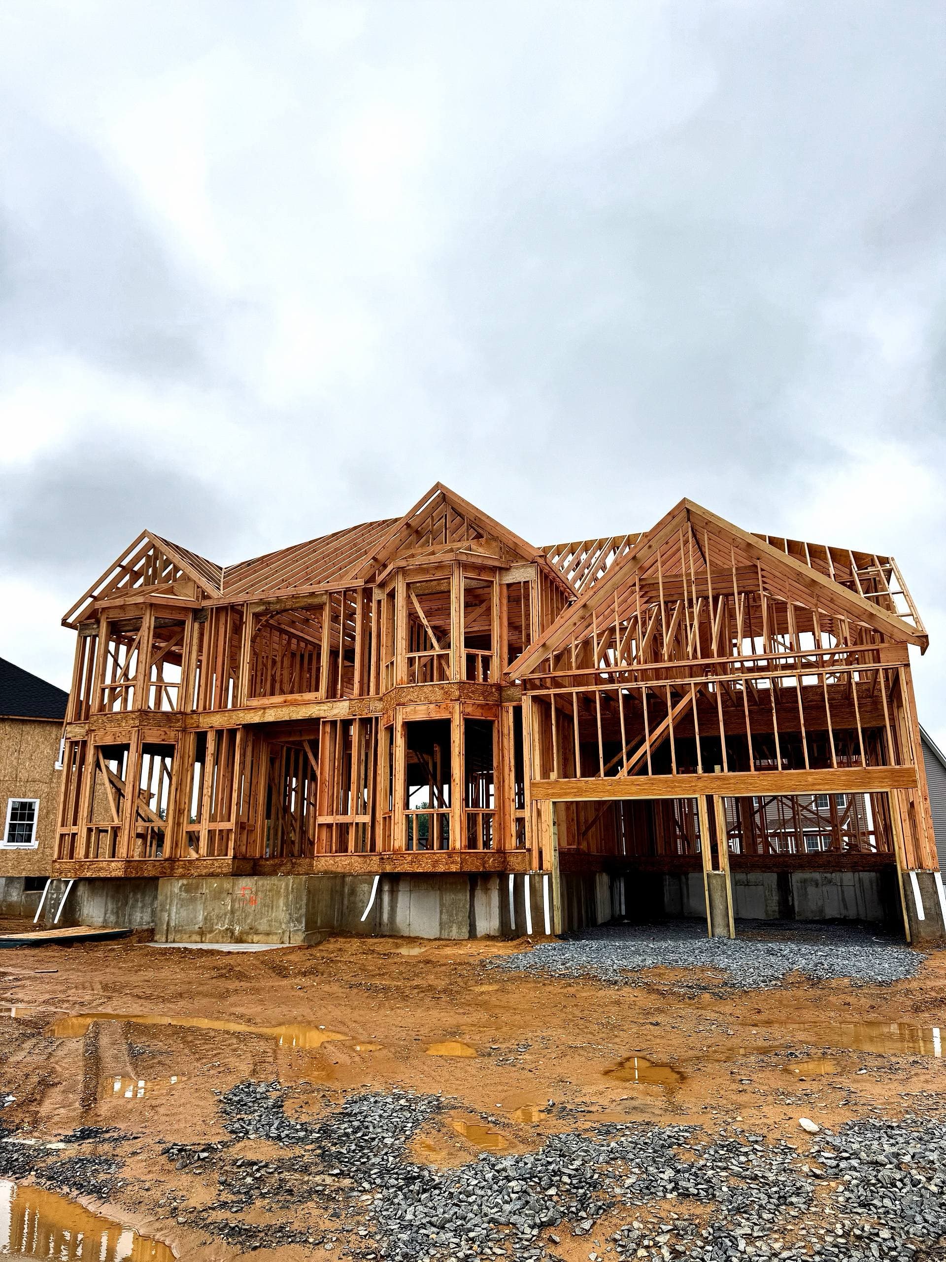 New home framing in progress with roof structure and wood wall framing