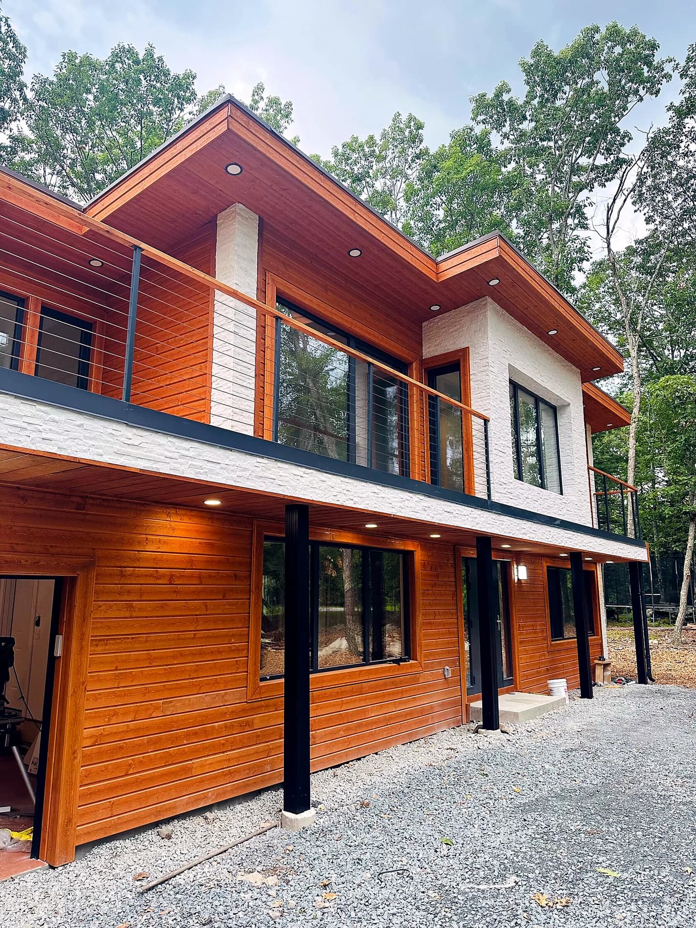 Finished exterior with wood facade and black rail details